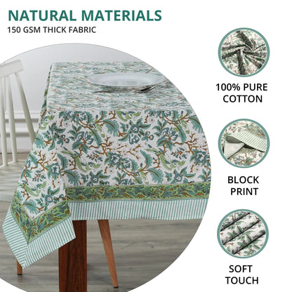 Tablecloth with floral pattern on a table, featuring text about natural materials and fabric details.
