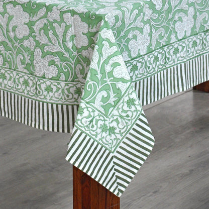 Green and white patterned tablecloth on a wooden table