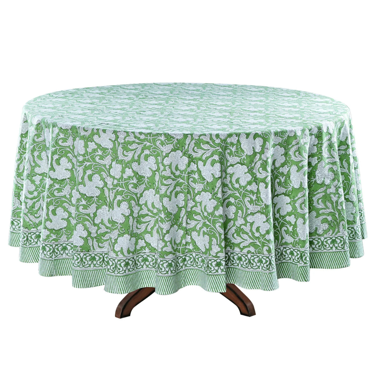 Green and white floral patterned tablecloth on a round table