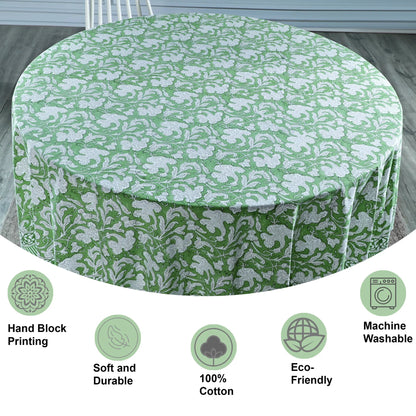Green floral-patterned tablecloth on a round table with features listed below.