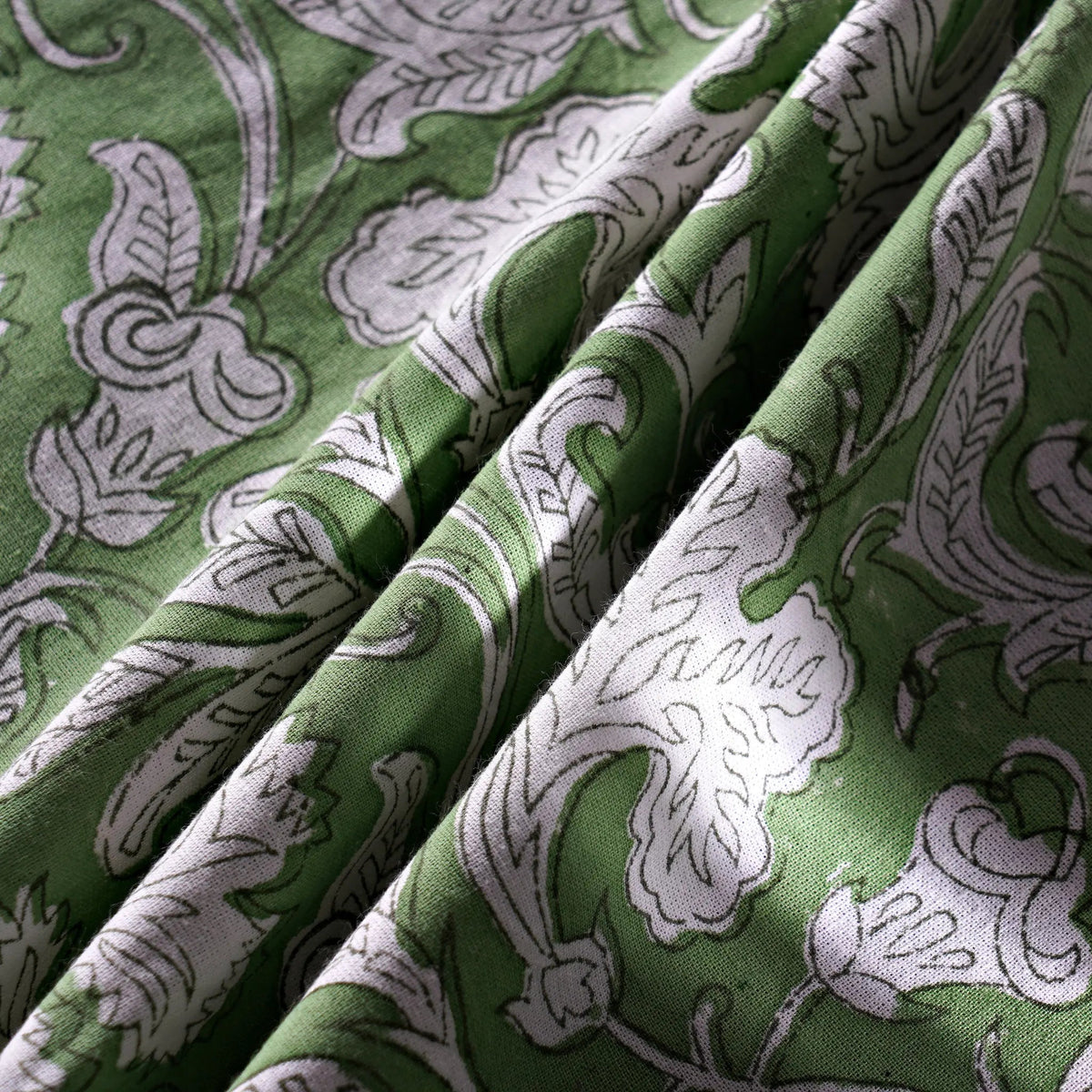 Green fabric with white floral patterns