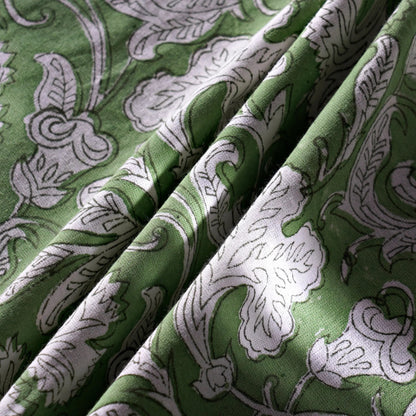 Green fabric with white floral patterns