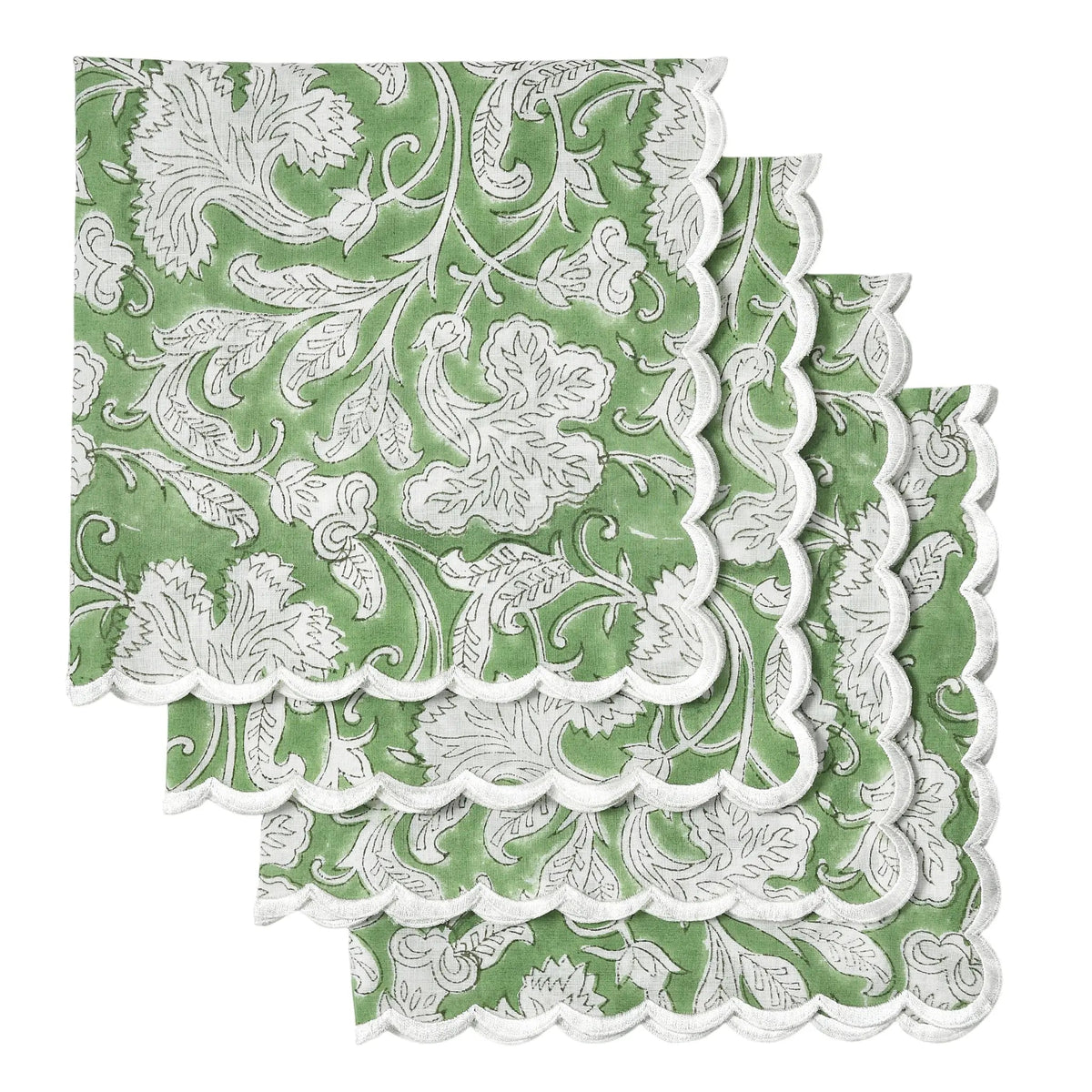 Green and white floral patterned paper napkins with scalloped edge on a white background