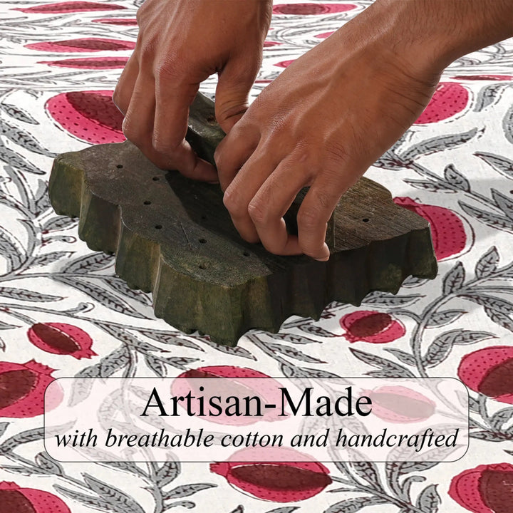 Hands working with a green block on a patterned fabric background, with text &
