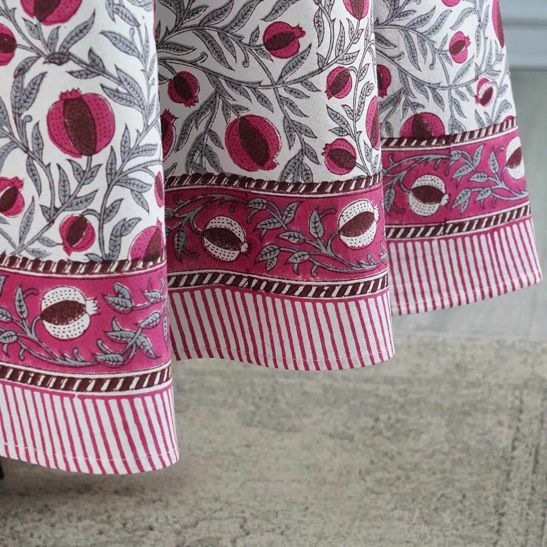 Close-up of a fabric with pomegranate pattern on a neutral background