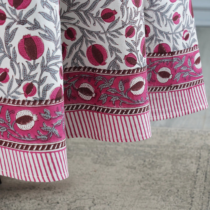 Close-up of a fabric with pomegranate pattern on a neutral background