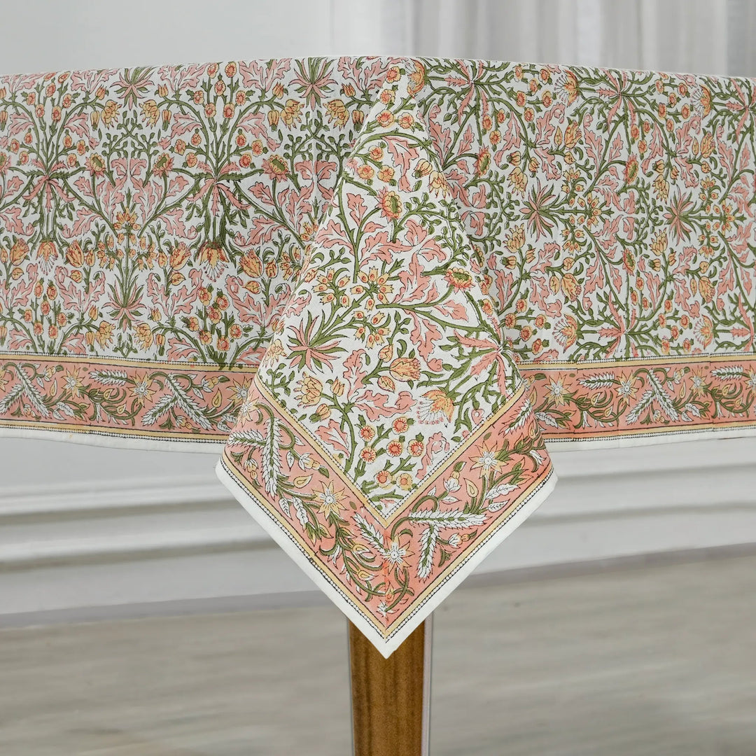 Floral patterned tablecloth on a wooden table with a white background