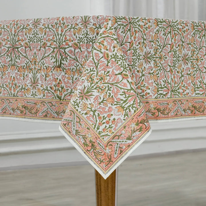 Floral patterned tablecloth on a wooden table with a white background