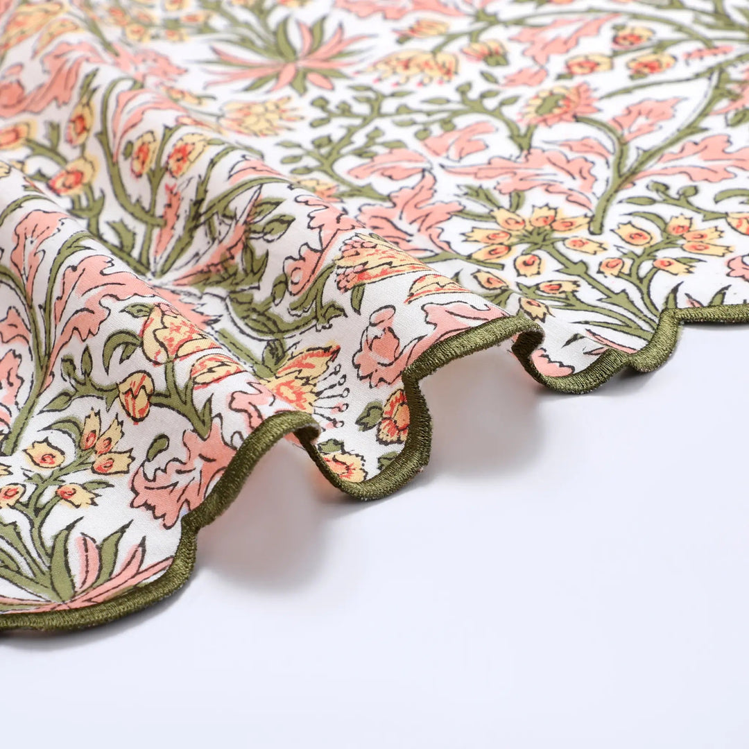 Floral patterned fabric with pink and green colors on a white background