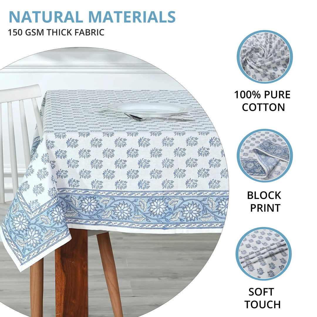 Tablecloth with blue floral pattern on a wooden table, featuring text about natural materials and fabric details.