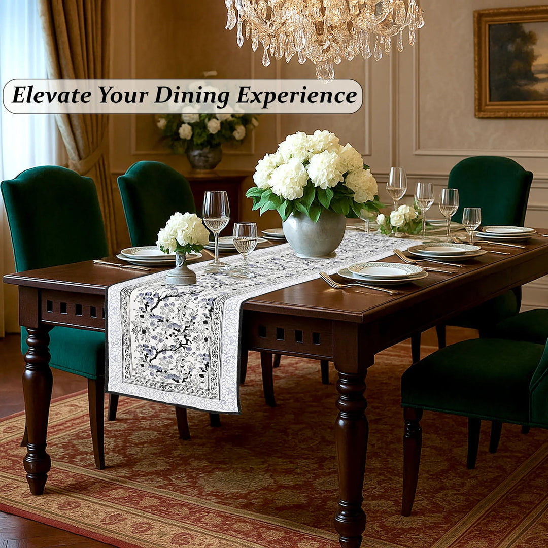 Dining room with a table set for dinner, flowers, and elegant decor.