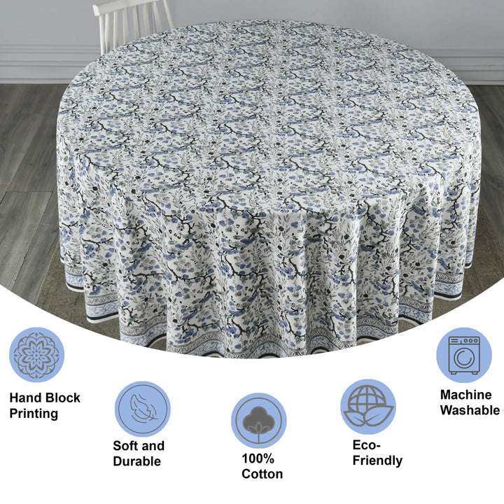 Floral patterned tablecloth on a round table with features highlighted.