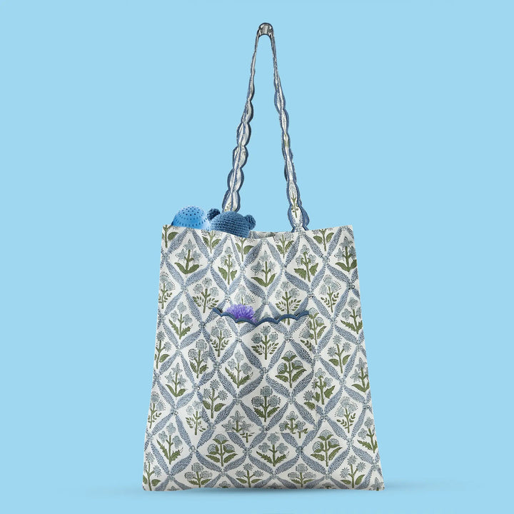 Patterned tote bag with floral design on a blue background