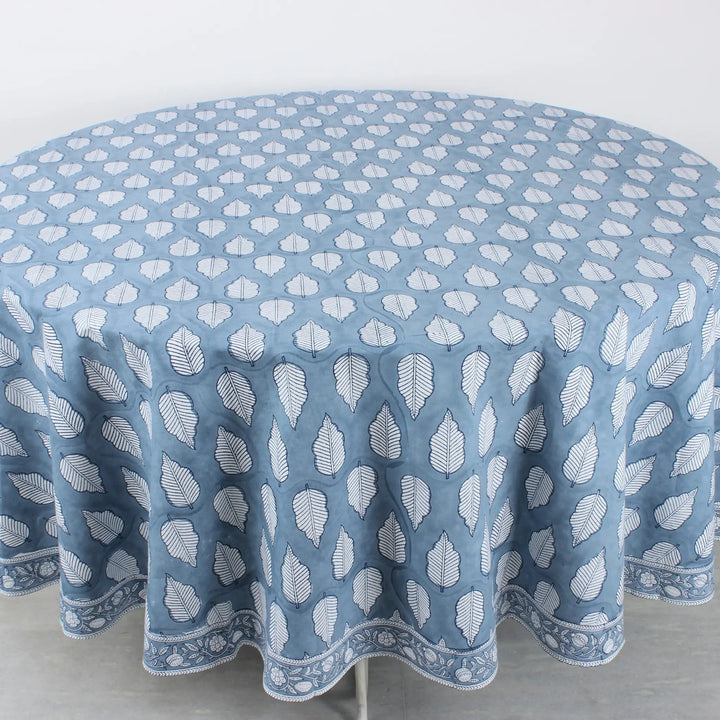 Round tablecloth with white leaf pattern on a blue background