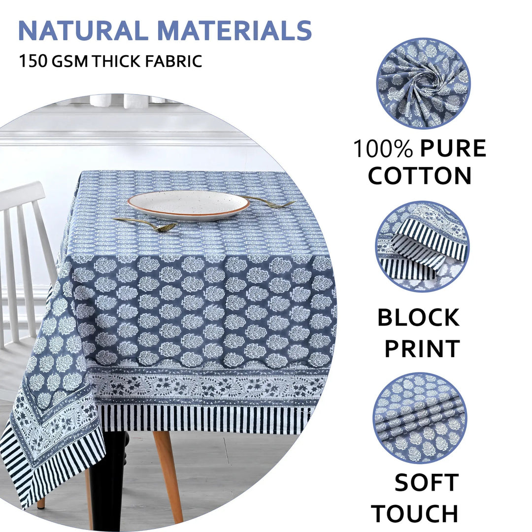 blue and white decorative cotton tablecloth with striped border on wooden table
