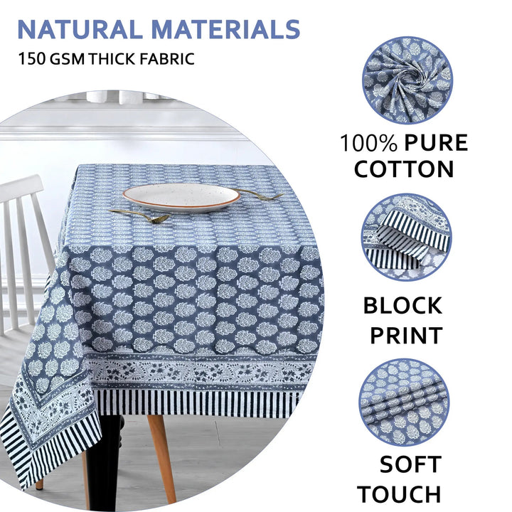 blue and white decorative cotton tablecloth with striped border on wooden table
