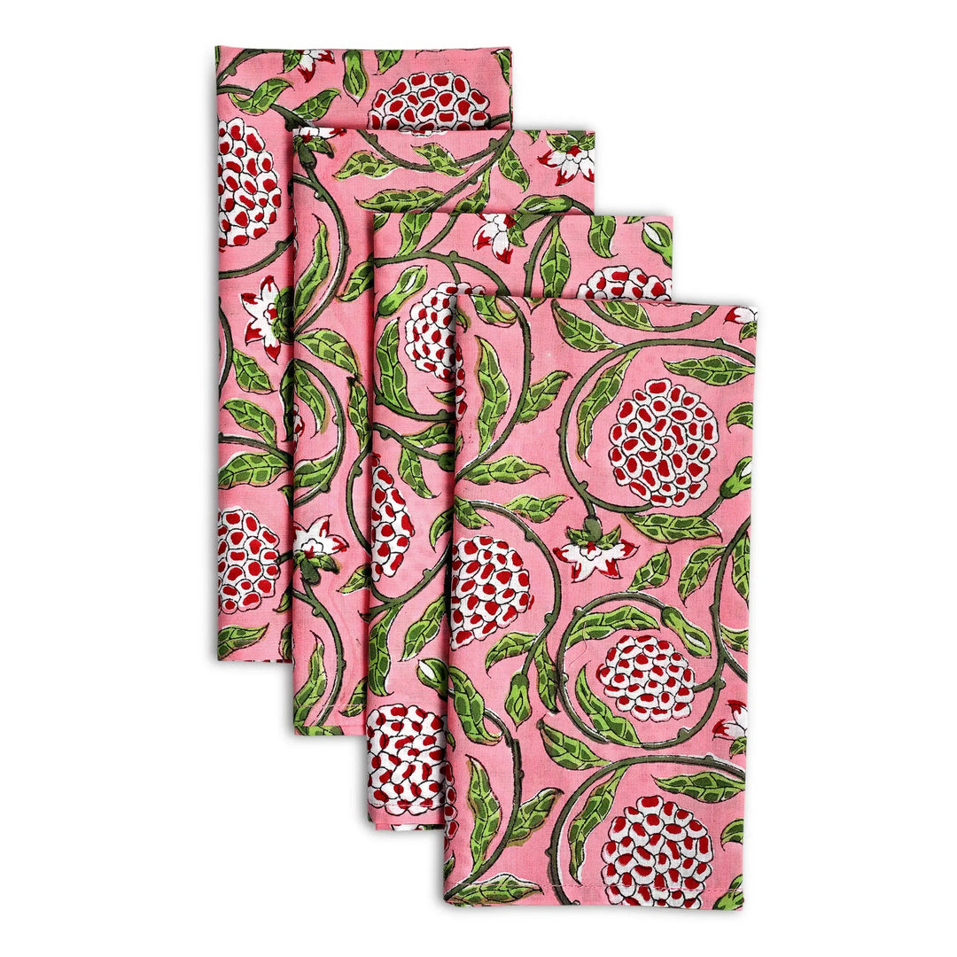 Set of four floral-patterned napkins on a white background
