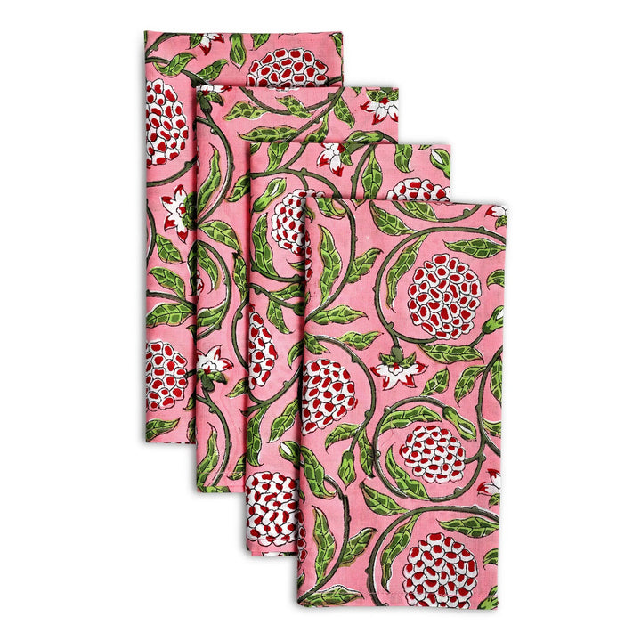 Set of four floral-patterned napkins on a white background