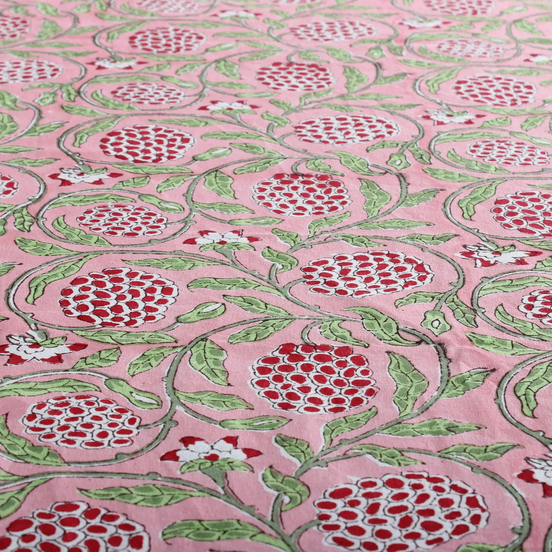 pink decorative tablecloth with striped border on wooden