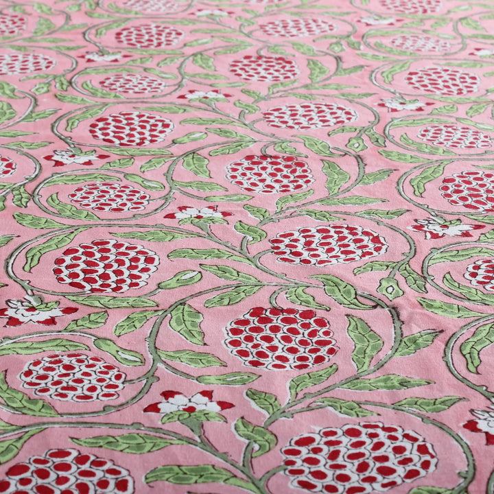 pink decorative tablecloth with striped border on wooden