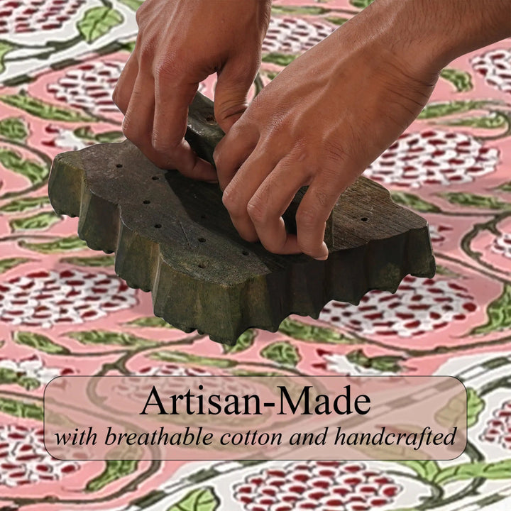 Hands using a textured green object on a patterned fabric background with &