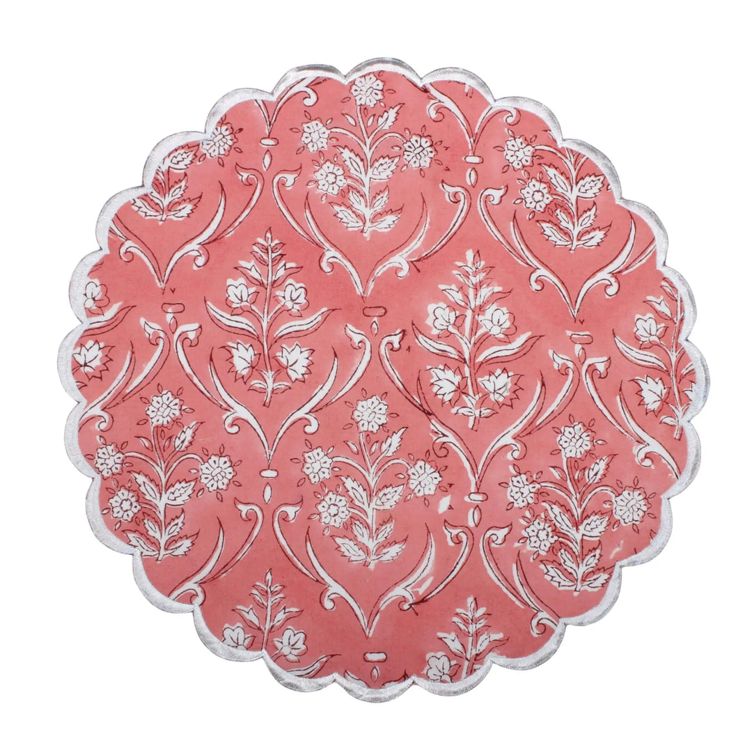 Decorative pink and white patterned plate on a white background