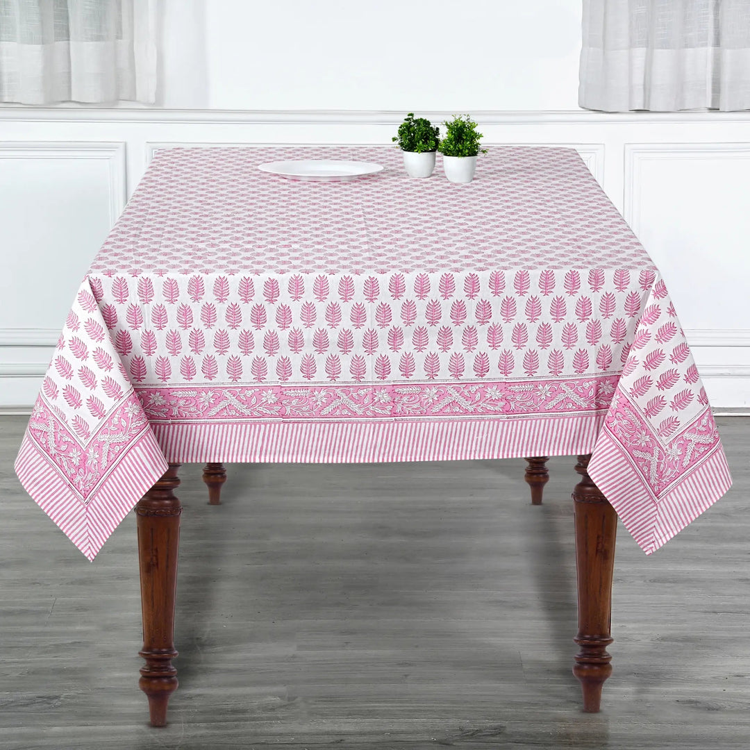 Tablecloth with pink and white pattern on a wooden table