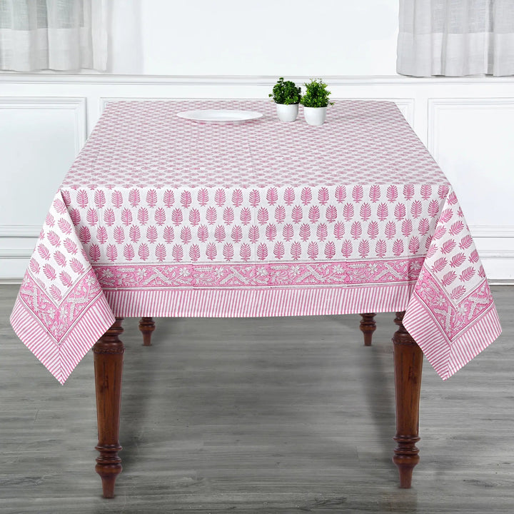 Tablecloth with pink and white pattern on a wooden table