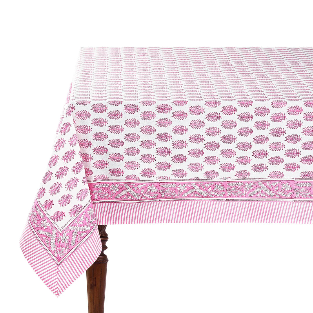 Pink and white patterned tablecloth on a wooden table