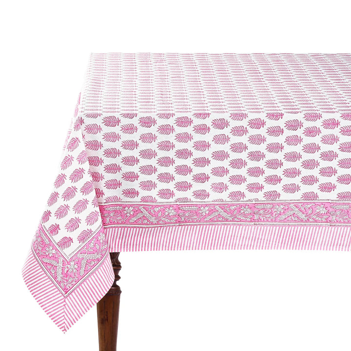 Pink and white patterned tablecloth on a wooden table