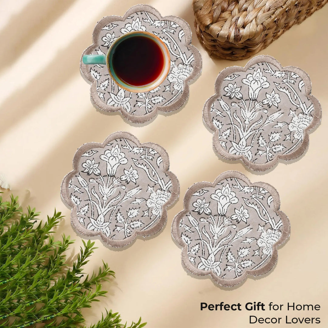 Set of floral coasters with a cup of coffee on a beige surface, accompanied by text &