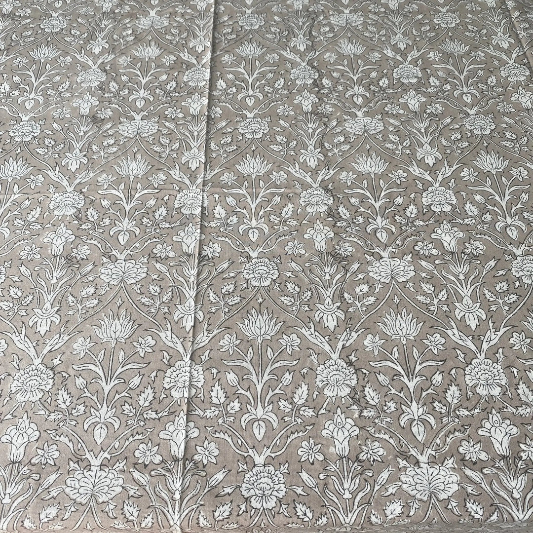 Floral patterned fabric with white flowers on a beige background
