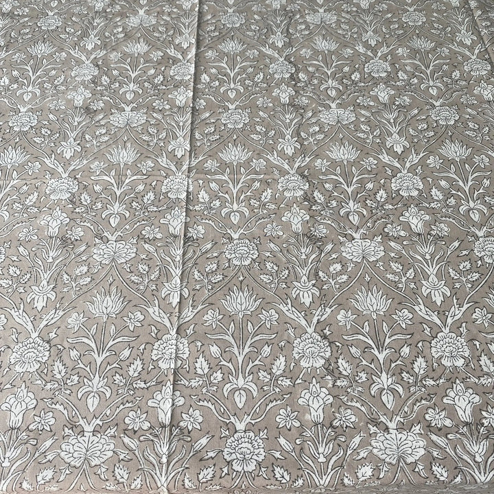 Floral patterned fabric with white flowers on a beige background