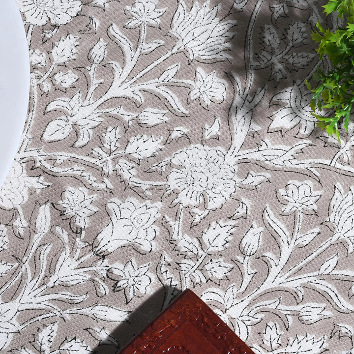 Floral patterned fabric with white flowers on a beige background