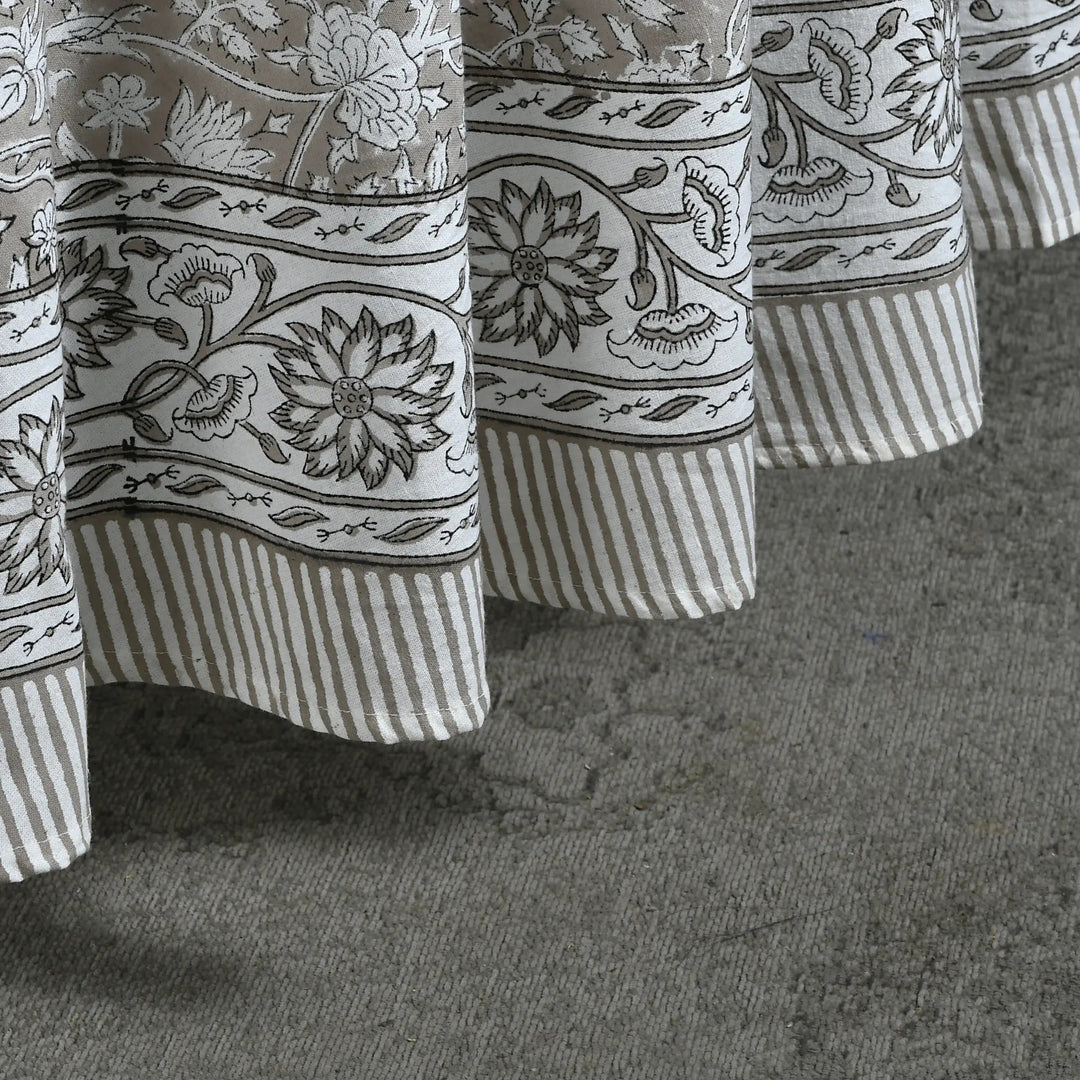 Close-up of patterned curtains on a textured surface