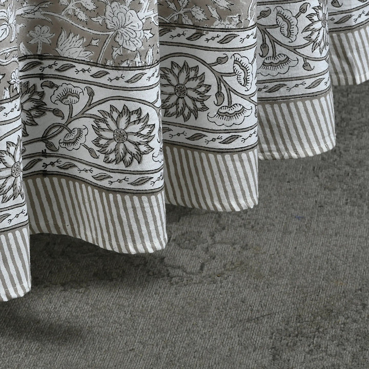 Close-up of patterned curtains on a textured surface