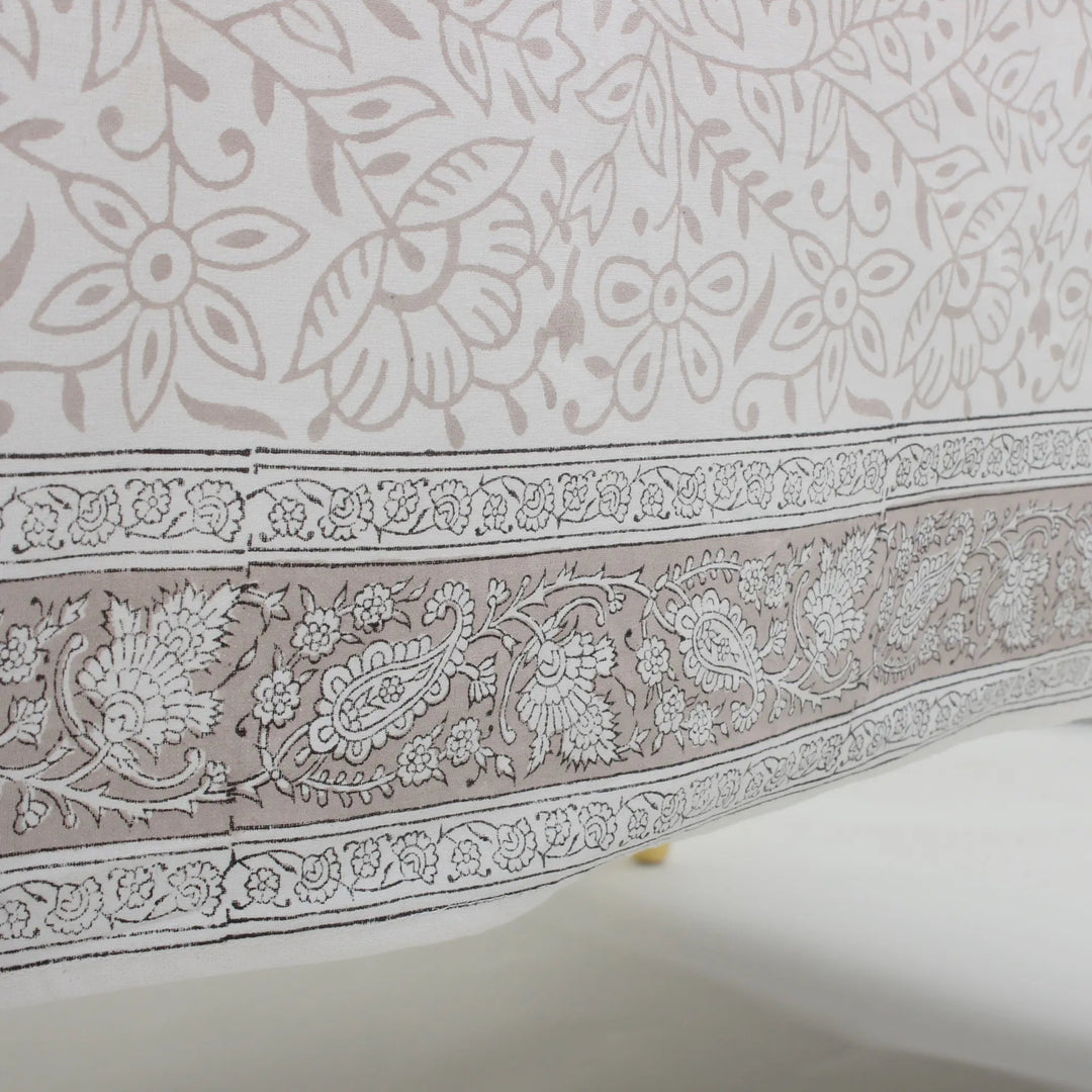 Close-up of a fabric with intricate paisley and floral patterns.