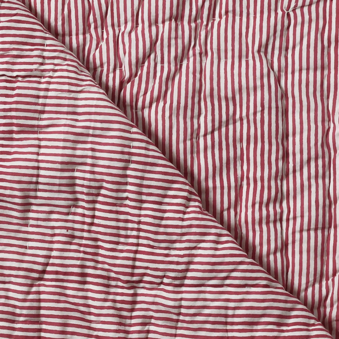 Red and white striped fabric with a textured surface