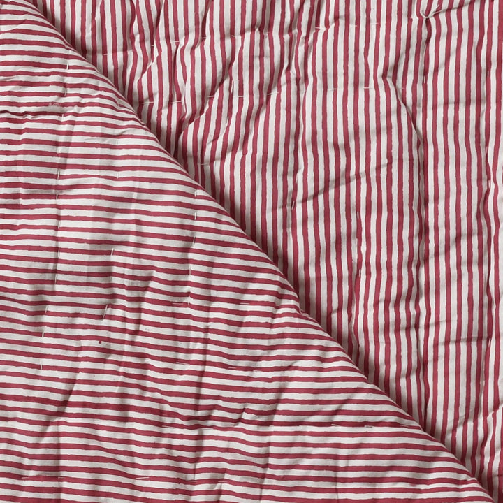 Red and white striped fabric with a textured surface