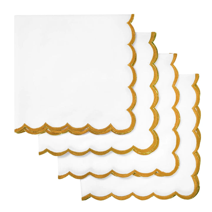 White napkins with gold scalloped edges on a white background