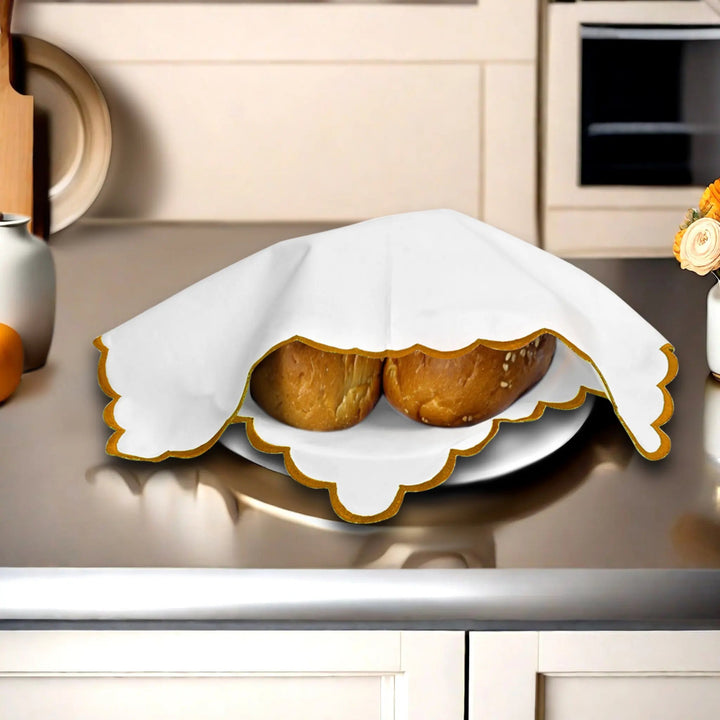 Two brown eggs on a white plate with a decorative white cover in a kitchen setting.