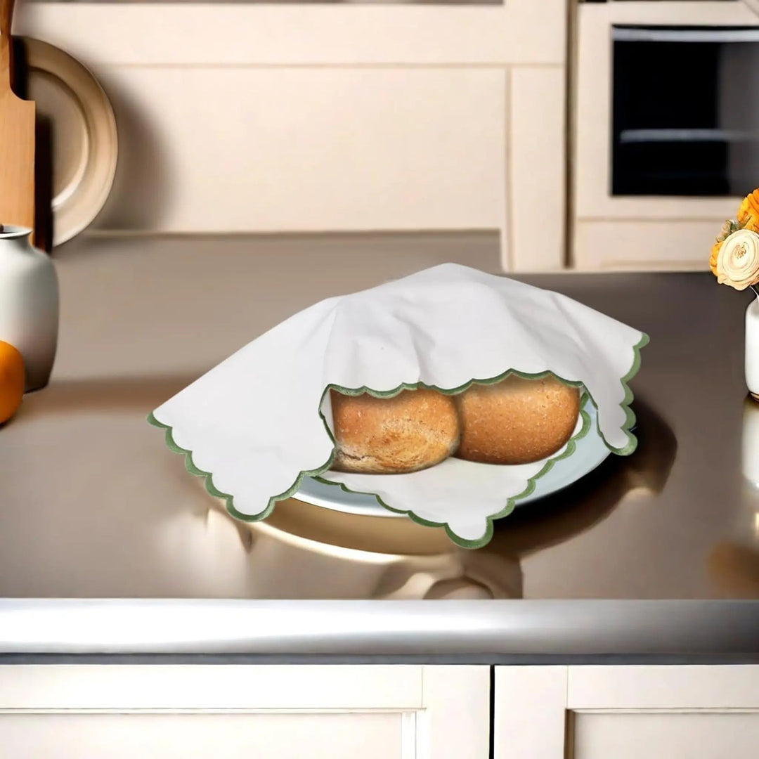 Two buns wrapped in paper on a kitchen counter