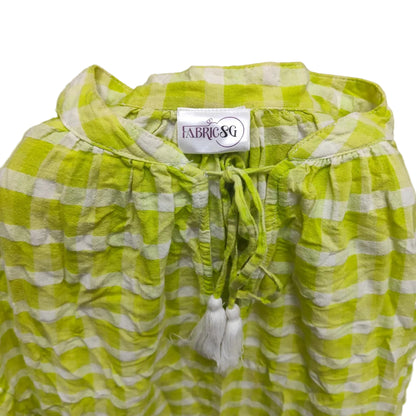 Green and white checkered garment with drawstring and tassel on a gray background