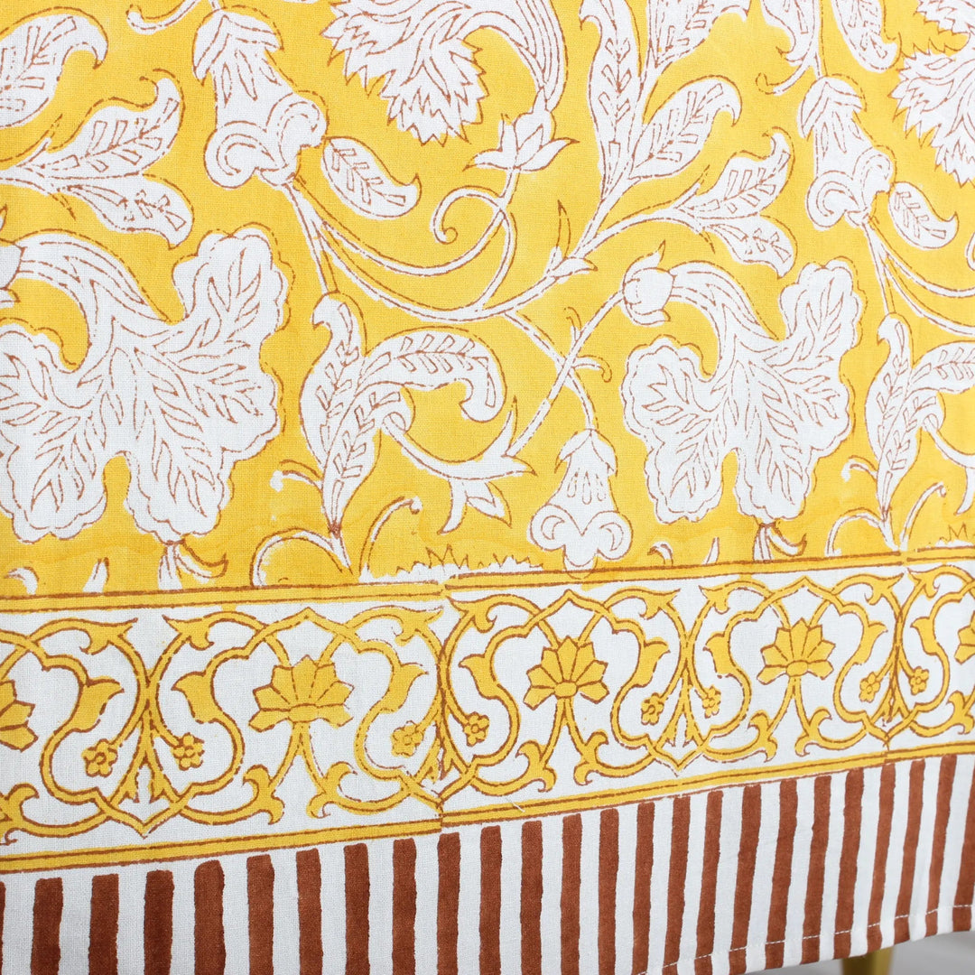 Decorative fabric with white floral patterns on a yellow background